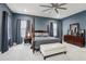 Inviting main bedroom featuring a plush four-poster bed, soft carpet, and ample natural light at 714 S Lois Ave, Tampa, FL 33609