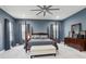 Spacious main bedroom with four poster bed, soft carpet, and soothing color palette at 714 S Lois Ave, Tampa, FL 33609