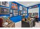 Bright blue office features sports memorabilia, desk with black chair, and a display shelf with model cars at 714 S Lois Ave, Tampa, FL 33609