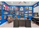 A sports themed office with blue walls decorated with framed memorabilia, memorabilia, and hardwood floors at 714 S Lois Ave, Tampa, FL 33609
