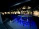 Outdoor kitchen boasts a built-in grill, bar seating, and blue accent lighting at 714 S Lois Ave, Tampa, FL 33609
