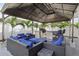 Relaxing outdoor lounge area featuring comfortable wicker seating and an outdoor kitchen with bar-style seating at 714 S Lois Ave, Tampa, FL 33609