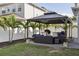 Inviting outdoor space with a covered patio, wicker seating, and a built-in grill area, perfect for entertaining at 714 S Lois Ave, Tampa, FL 33609