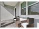 Relax on the patio with wicker chairs and a center table near the window at 714 S Lois Ave, Tampa, FL 33609