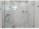 Elegant walk-in shower featuring sleek glass enclosure and marble tiling at 714 S Lois Ave, Tampa, FL 33609