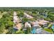 An aerial view shows single-Gathering homes with pools in a landscaped neighborhood near a pond and trees at 9308 Fairway Lakes Ct, Tampa, FL 33647