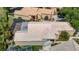 Aerial view of home with screened lanai, tiled roof, well-manicured lawn, and desert landscaping at 9308 Fairway Lakes Ct, Tampa, FL 33647