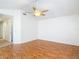 Bright bedroom with hardwood flooring and a ceiling fan offering a comfortable living space at 9308 Fairway Lakes Ct, Tampa, FL 33647