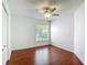 Cozy bedroom with hardwood floors, ceiling fan, and natural light at 9308 Fairway Lakes Ct, Tampa, FL 33647