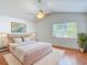 Staged bedroom with hardwood floors, bright lighting, and tastefully coordinated furniture for a welcoming atmosphere at 9308 Fairway Lakes Ct, Tampa, FL 33647
