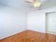 A clean bedroom with light walls, laminate floors and a ceiling fan at 9308 Fairway Lakes Ct, Tampa, FL 33647
