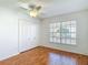 Bedroom with large closet, window and laminate floors at 9308 Fairway Lakes Ct, Tampa, FL 33647