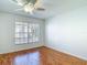 Cozy bedroom featuring laminate flooring and a bright window overlooking the neighborhood at 9308 Fairway Lakes Ct, Tampa, FL 33647