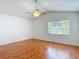 Spacious bedroom with hardwood flooring and a large window providing natural light and a pleasant view at 9308 Fairway Lakes Ct, Tampa, FL 33647