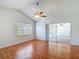 Bright bedroom with hardwood floors and sliding glass doors to an outdoor space enhancing its appeal at 9308 Fairway Lakes Ct, Tampa, FL 33647