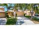 Charming single-story home with a tile roof, well-manicured lawn, and a two-car garage at 9308 Fairway Lakes Ct, Tampa, FL 33647