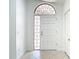 Interior shot of front door with sidelight and foyer with tile floor at 9308 Fairway Lakes Ct, Tampa, FL 33647