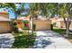 Charming single-story home featuring a well-maintained yard, two-car garage, and tile roof at 9308 Fairway Lakes Ct, Tampa, FL 33647