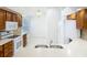 Bright kitchen with wood cabinets, white appliances, and a breakfast nook, perfect for casual dining at 9308 Fairway Lakes Ct, Tampa, FL 33647