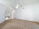 Inviting living room featuring high ceilings, neutral carpet, and a ceiling fan for added comfort at 9308 Fairway Lakes Ct, Tampa, FL 33647