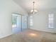 Spacious living room with sliding doors to the lanai, featuring neutral carpet and plenty of light at 9308 Fairway Lakes Ct, Tampa, FL 33647