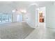 Open-concept living room with vaulted ceilings flowing into the dining and kitchen areas at 9308 Fairway Lakes Ct, Tampa, FL 33647