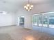 Large living room with access to multiple lanai areas, providing a seamless indoor-outdoor flow at 9308 Fairway Lakes Ct, Tampa, FL 33647