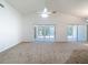 Large, airy living room showcases sliding glass doors and neutral carpeting at 9308 Fairway Lakes Ct, Tampa, FL 33647