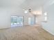 Spacious living area features vaulted ceilings and natural light from sliding glass doors at 9308 Fairway Lakes Ct, Tampa, FL 33647