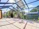 Screened patio boasts tile flooring and views of the yard, creating a cozy outdoor retreat at 9308 Fairway Lakes Ct, Tampa, FL 33647