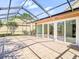 Spacious screened patio with tiled floor and sliding glass doors provides an outdoor relaxation space at 9308 Fairway Lakes Ct, Tampa, FL 33647