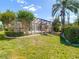 A beautiful home featuring a large screened-in patio and well-maintained lawn, perfect for outdoor relaxation at 9308 Fairway Lakes Ct, Tampa, FL 33647