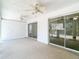 Sunroom features carpeting, ceiling fans, and multiple sliding glass doors providing ample light and access at 9308 Fairway Lakes Ct, Tampa, FL 33647