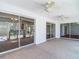 Cozy sunroom featuring neutral carpeting, ceiling fans, and several sliding glass doors for natural light and accessibility at 9308 Fairway Lakes Ct, Tampa, FL 33647