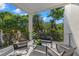 Inviting balcony with comfortable seating and a lush tropical landscape, ideal for relaxation and enjoying nature at 98 W Davis Blvd, Tampa, FL 33606