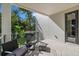 A stylish outdoor balcony featuring comfortable seating and lush greenery, perfect for relaxation at 98 W Davis Blvd, Tampa, FL 33606
