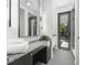 Modern bathroom featuring a granite vanity and large mirror with contemporary lighting at 98 W Davis Blvd, Tampa, FL 33606
