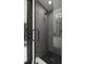 Modern bathroom featuring an open glass shower with a sleek black rain shower head and floor tiling at 98 W Davis Blvd, Tampa, FL 33606