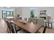 Open-concept dining area featuring a large wood table, modern chairs, and plenty of natural light at 98 W Davis Blvd, Tampa, FL 33606