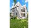 Multi-story house features a clean white exterior, balconies, and well-kept backyard at 98 W Davis Blvd, Tampa, FL 33606