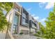 Modern townhomes with large windows, a two-car garage, professional landscaping, and modern design at 98 W Davis Blvd, Tampa, FL 33606