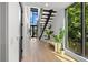 Modern foyer featuring wood floors, an open staircase, and large windows offering ample light at 98 W Davis Blvd, Tampa, FL 33606