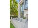 Front entrance with stone retaining wall, a manicured garden, and large glass front door at 98 W Davis Blvd, Tampa, FL 33606