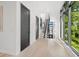 Bright hallway with wooden floors, a modern staircase and large windows showing green foliage at 98 W Davis Blvd, Tampa, FL 33606