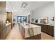 Spacious kitchen featuring a large center island with a waterfall countertop, seating, and wood cabinets at 98 W Davis Blvd, Tampa, FL 33606