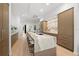Modern kitchen with a large island, waterfall countertop, seating, and stainless steel appliances at 98 W Davis Blvd, Tampa, FL 33606