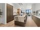 Modern kitchen with an oversized waterfall island, wood cabinets, and stainless steel appliances at 98 W Davis Blvd, Tampa, FL 33606