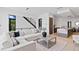 Bright living room with a white sectional, modern staircase, and natural light at 98 W Davis Blvd, Tampa, FL 33606