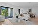 Bright living room with a large white sofa, modern décor, and floor-to-ceiling windows providing great natural light at 98 W Davis Blvd, Tampa, FL 33606
