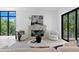 Bright living room with a modern fireplace, stylish chairs, and a large window overlooking the greenery at 98 W Davis Blvd, Tampa, FL 33606